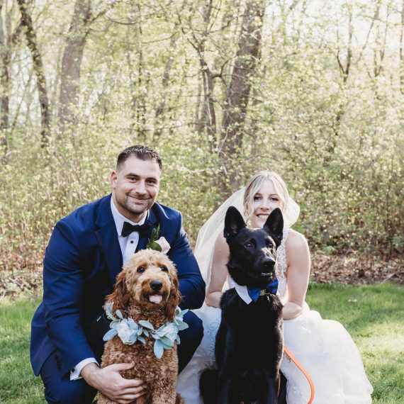 Couple poses with their dogs