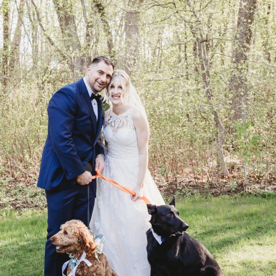 Couple poses with their dogs